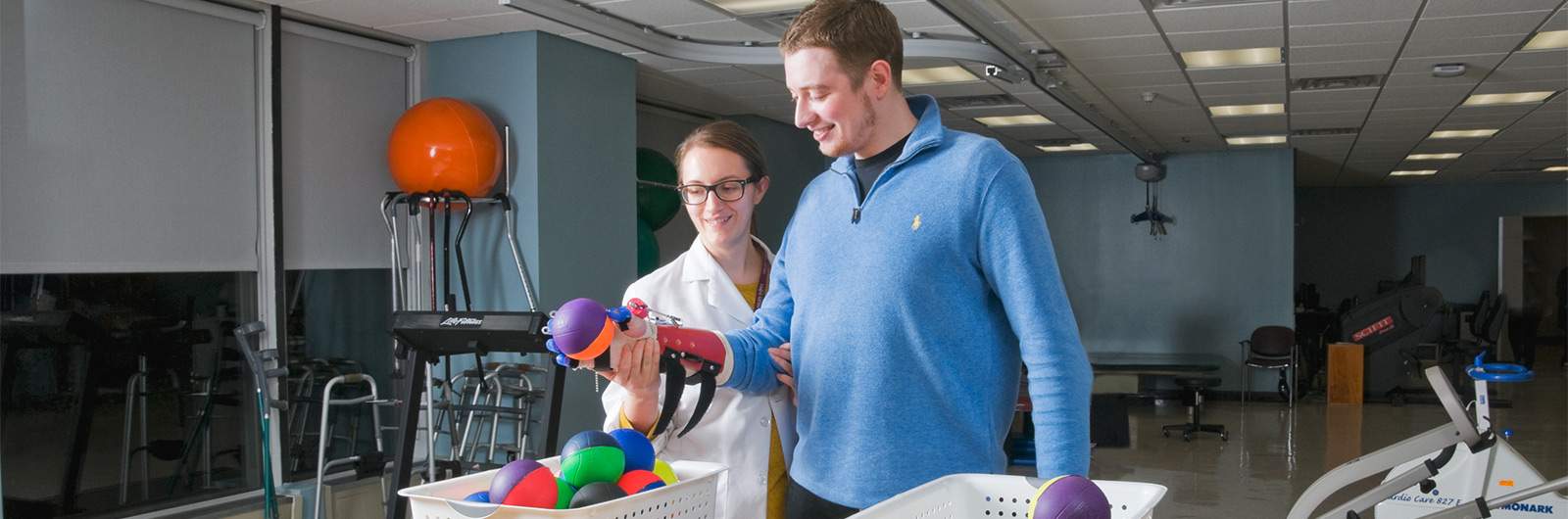 Physical Therapy Physical Therapist and Patient holding a ball