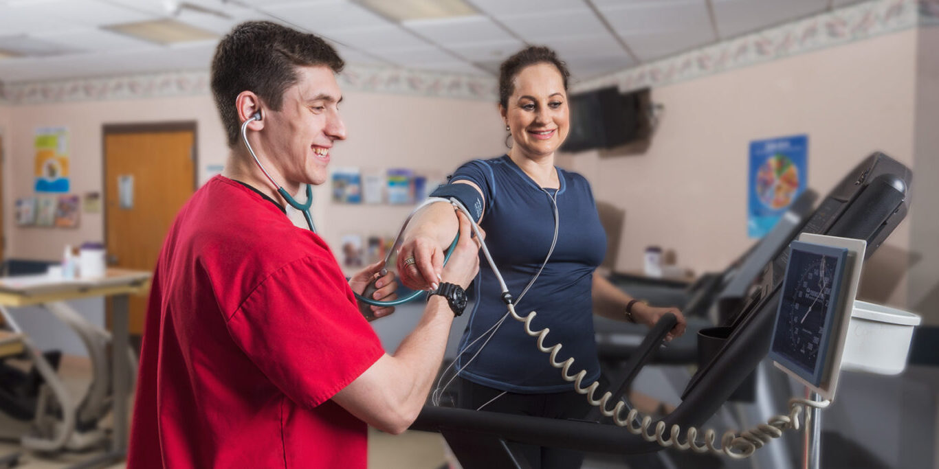 Exercise physiologist checking blood pressure