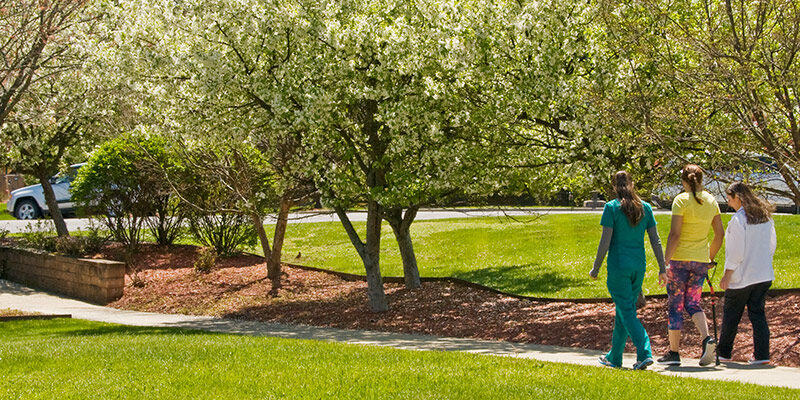 Helen Hayes staff and patient walking outside on campus